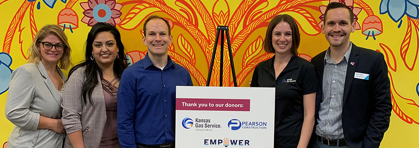 Kansas Gas Service group of people standing with sign